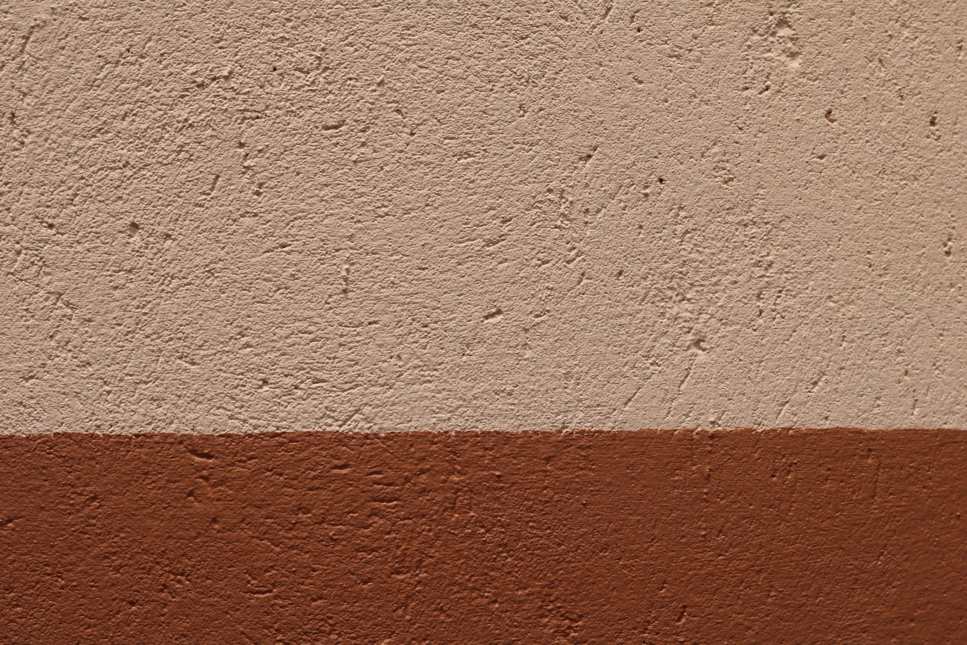 a brown and white wall with a red stripe